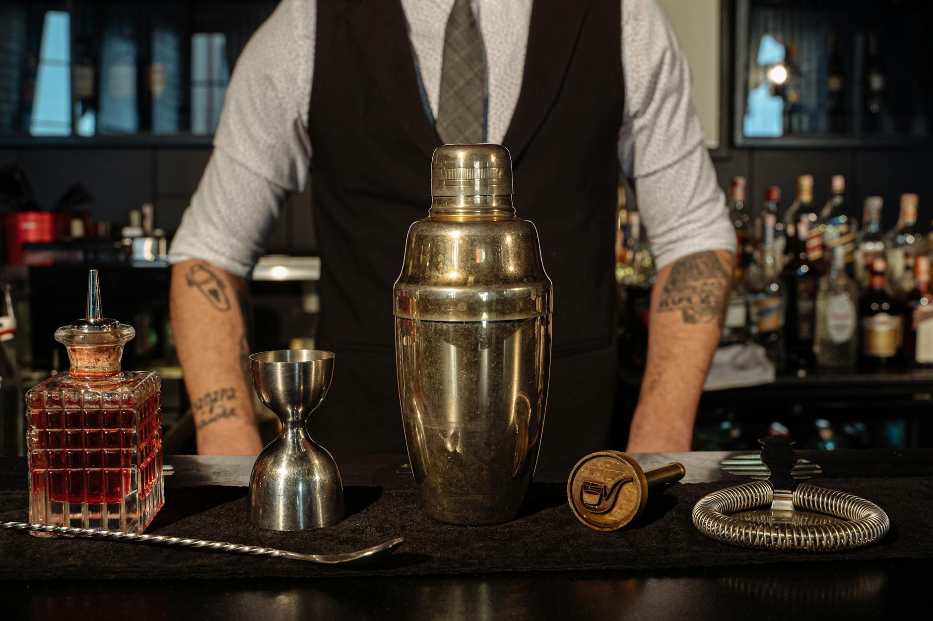 Stainless Steel Shaker and Wine Measuring Cup on the Bar Counter