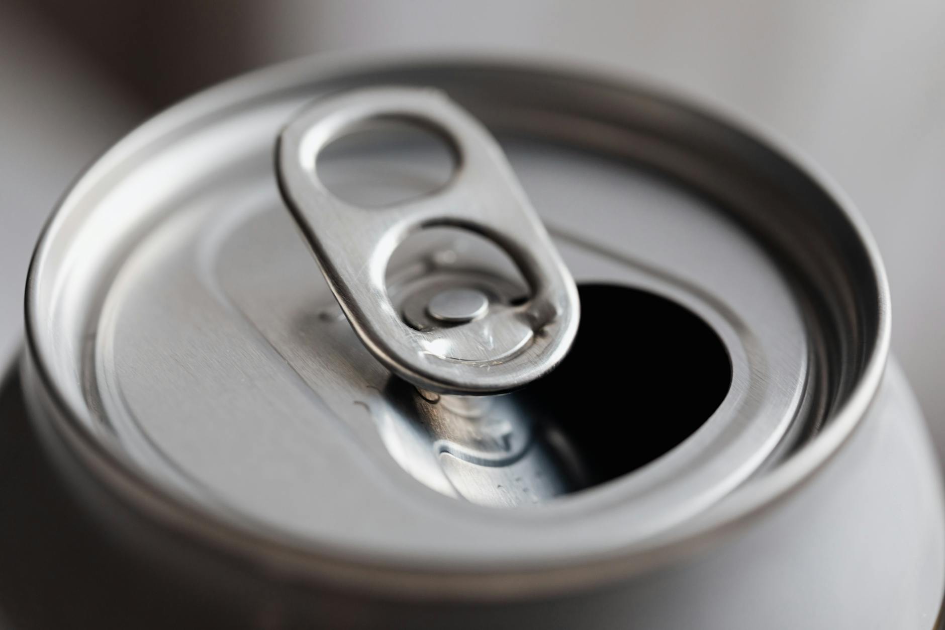 Open grey metal soda can