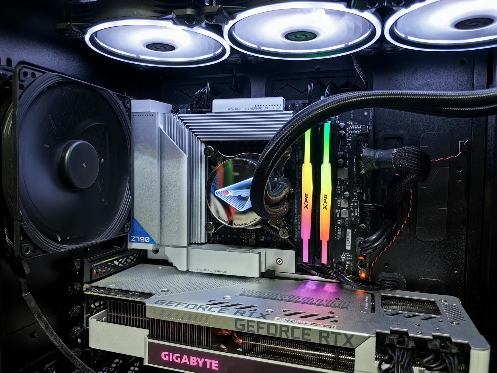 A computer case with a fan and a rainbow colored light