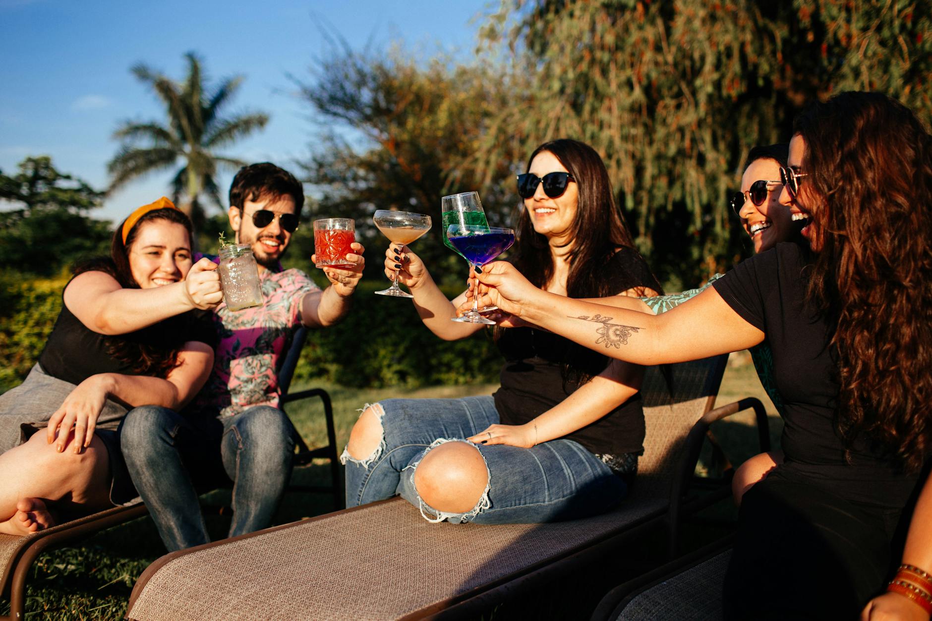 Group of friends drinking alcoholic beverages in park