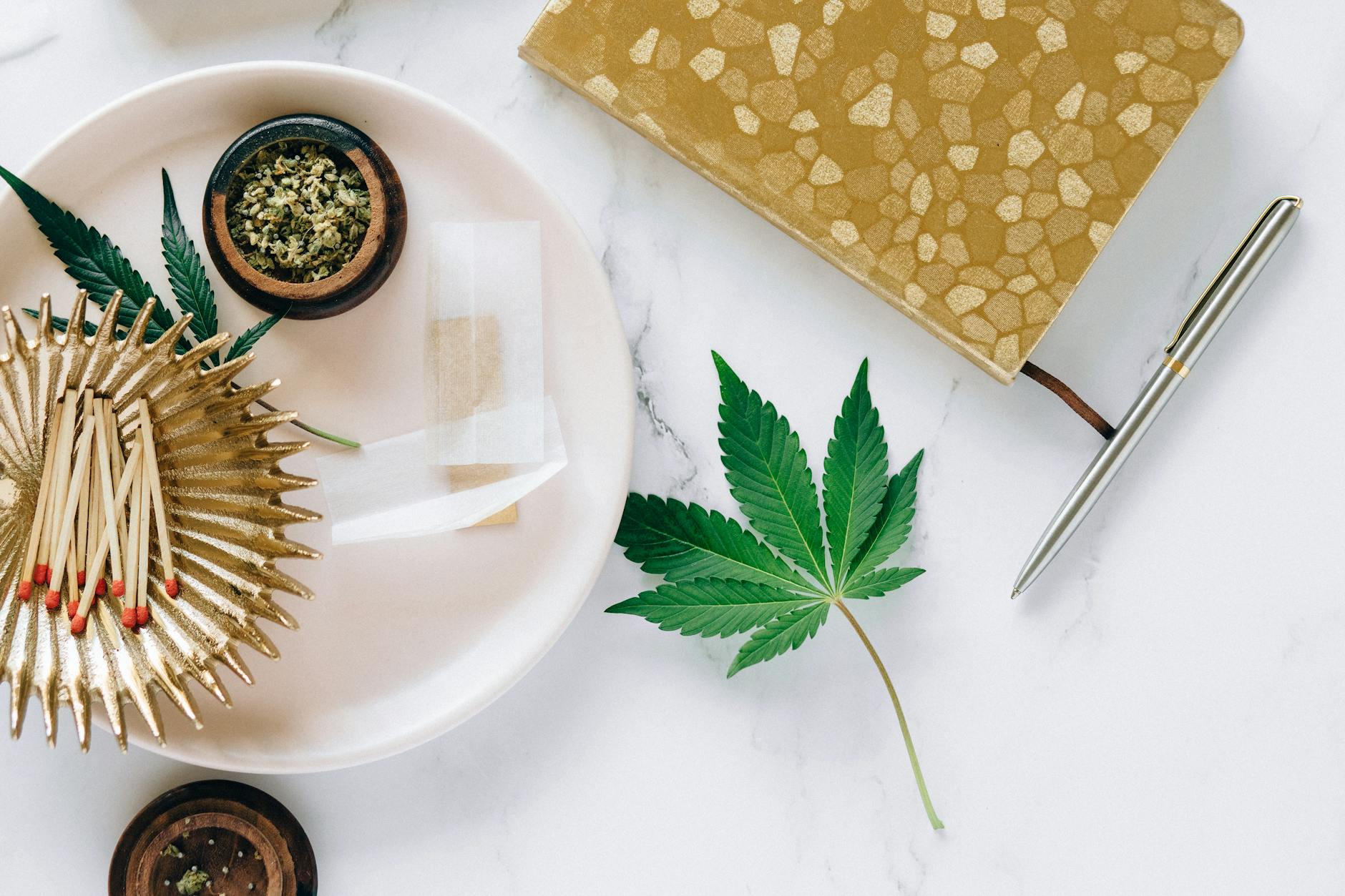 Cannabis Leaf on White Marble Surface