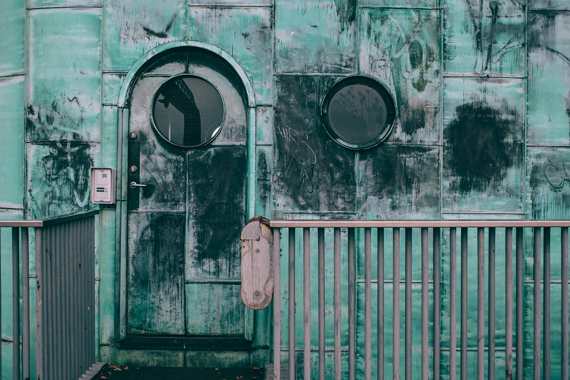 Old shabby cabin with combination lock and round windows