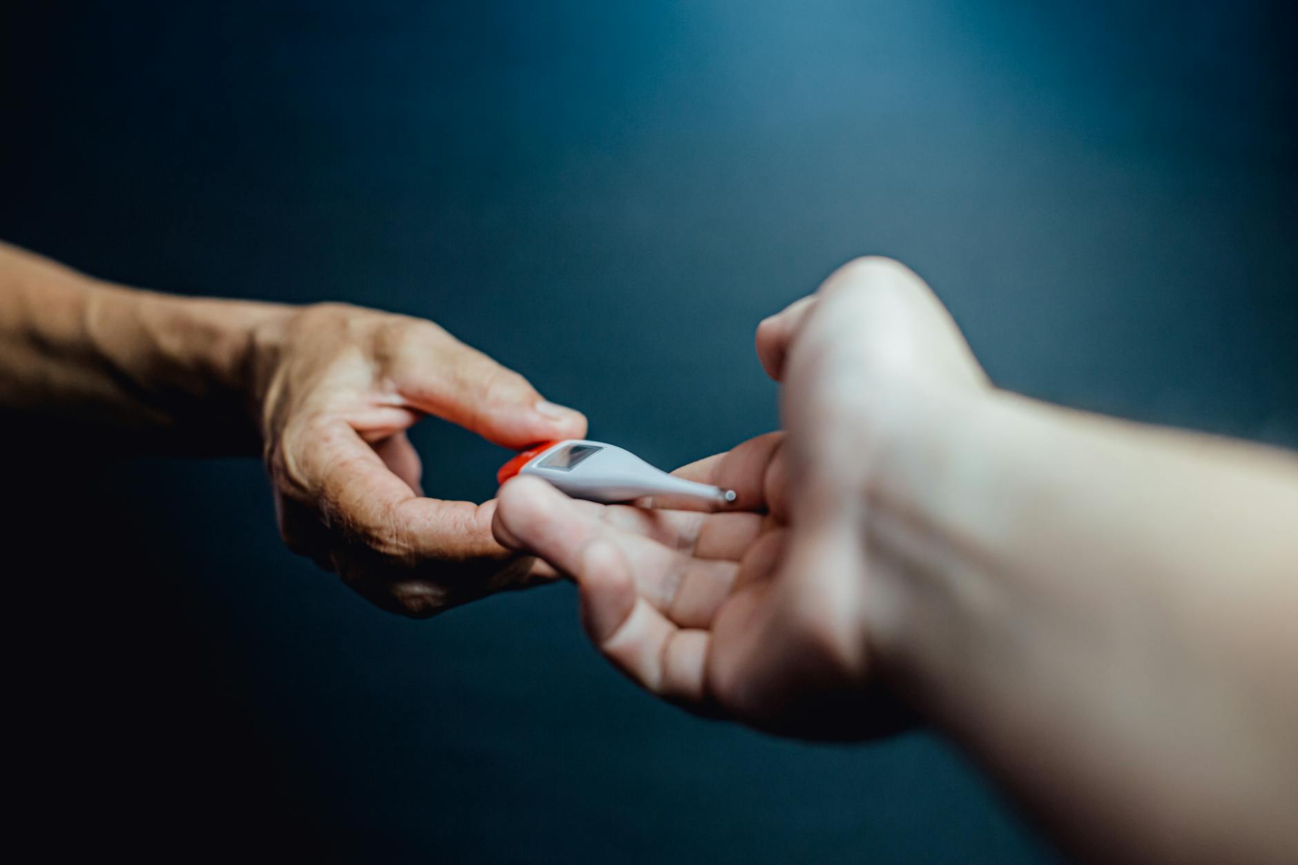 Crop person handing over medical thermometer