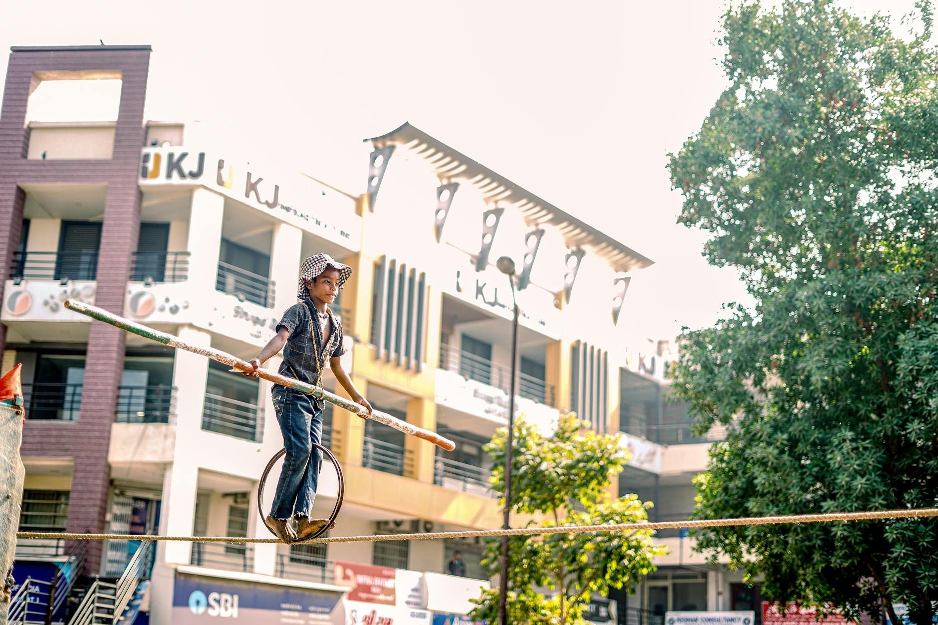 Boy on Wheel Balancing on Rope