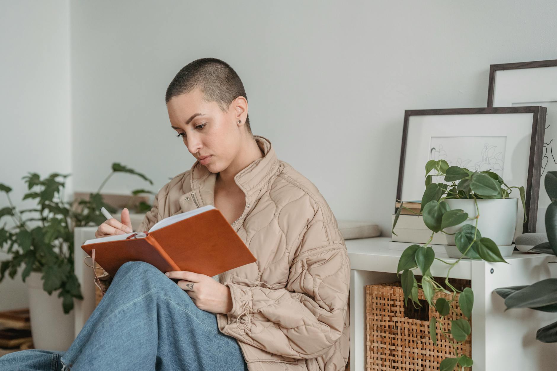 Attentive woman writing in diary at home