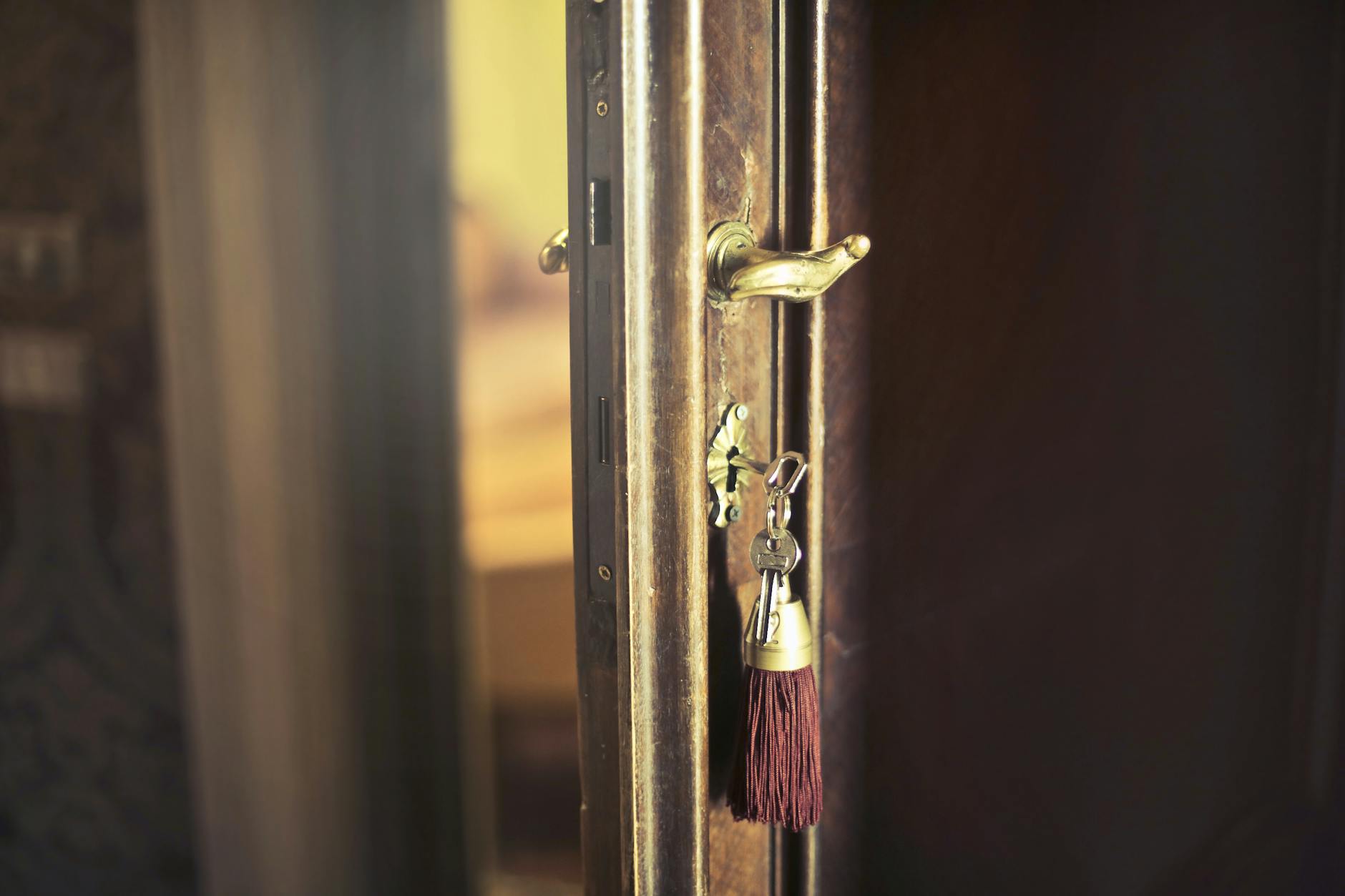 Key with trinket in shabby door