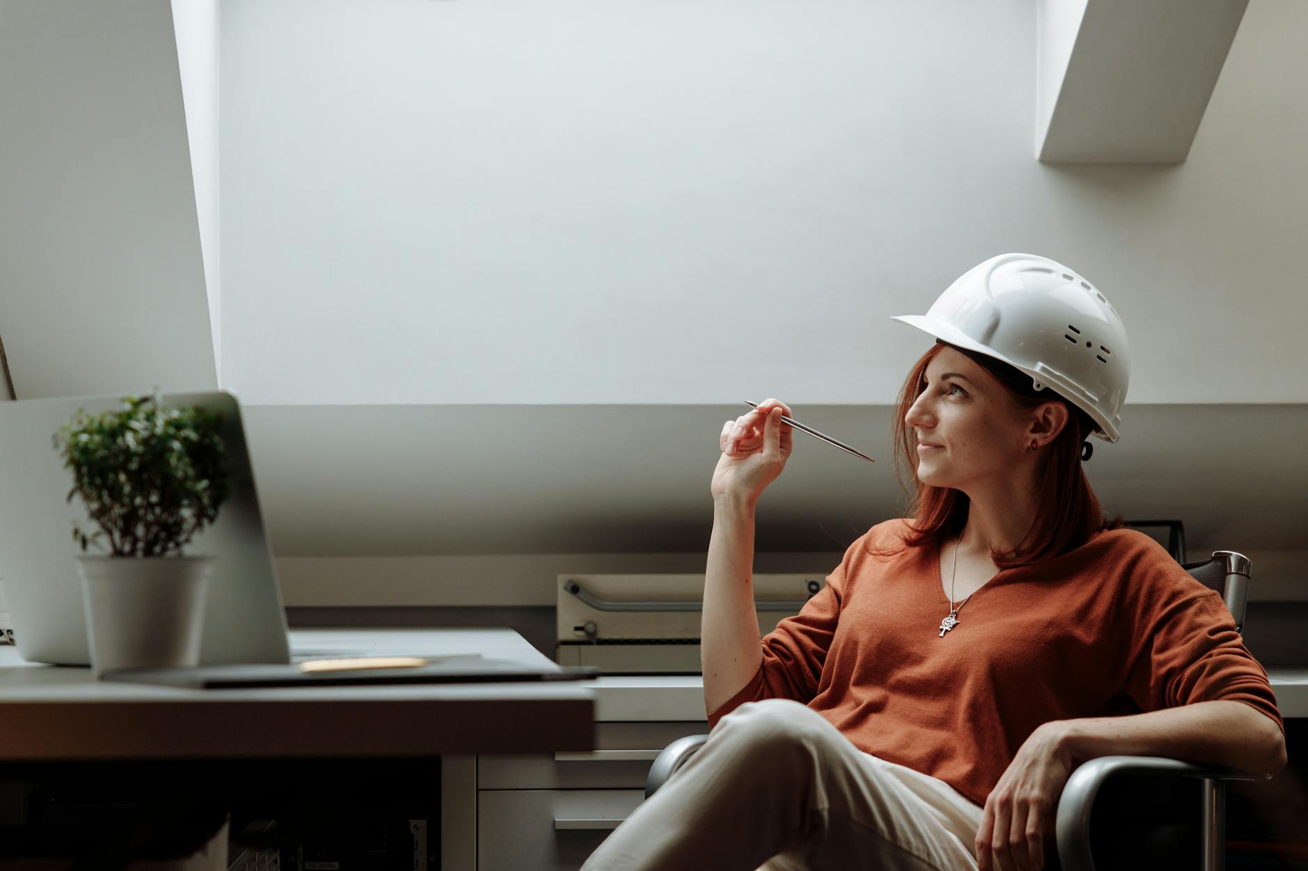 Smiling Woman Thinking While Wearing White Hard Hat