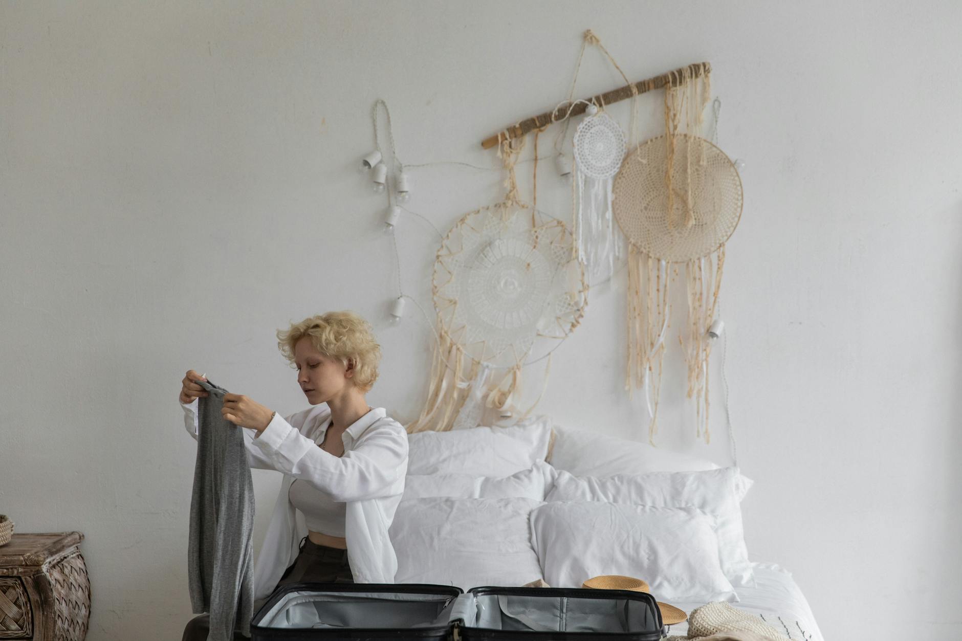 Calm woman packing luggage in bedroom