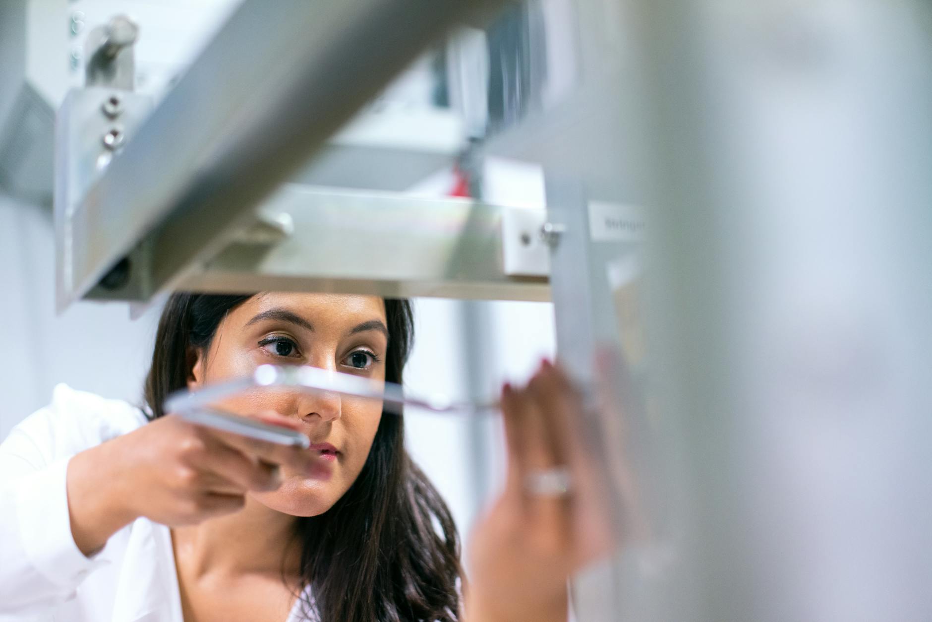 Photo Of Female Engineer Working On An Equipment