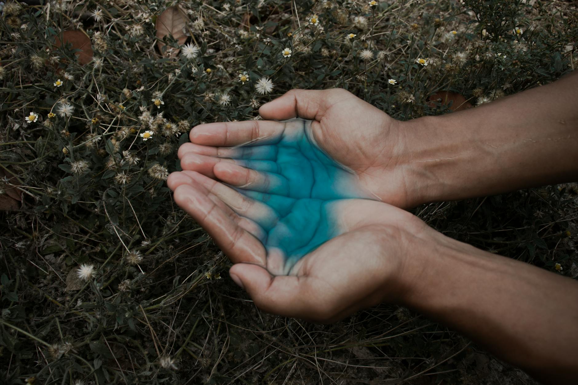 Human Hand With Blue Liquid