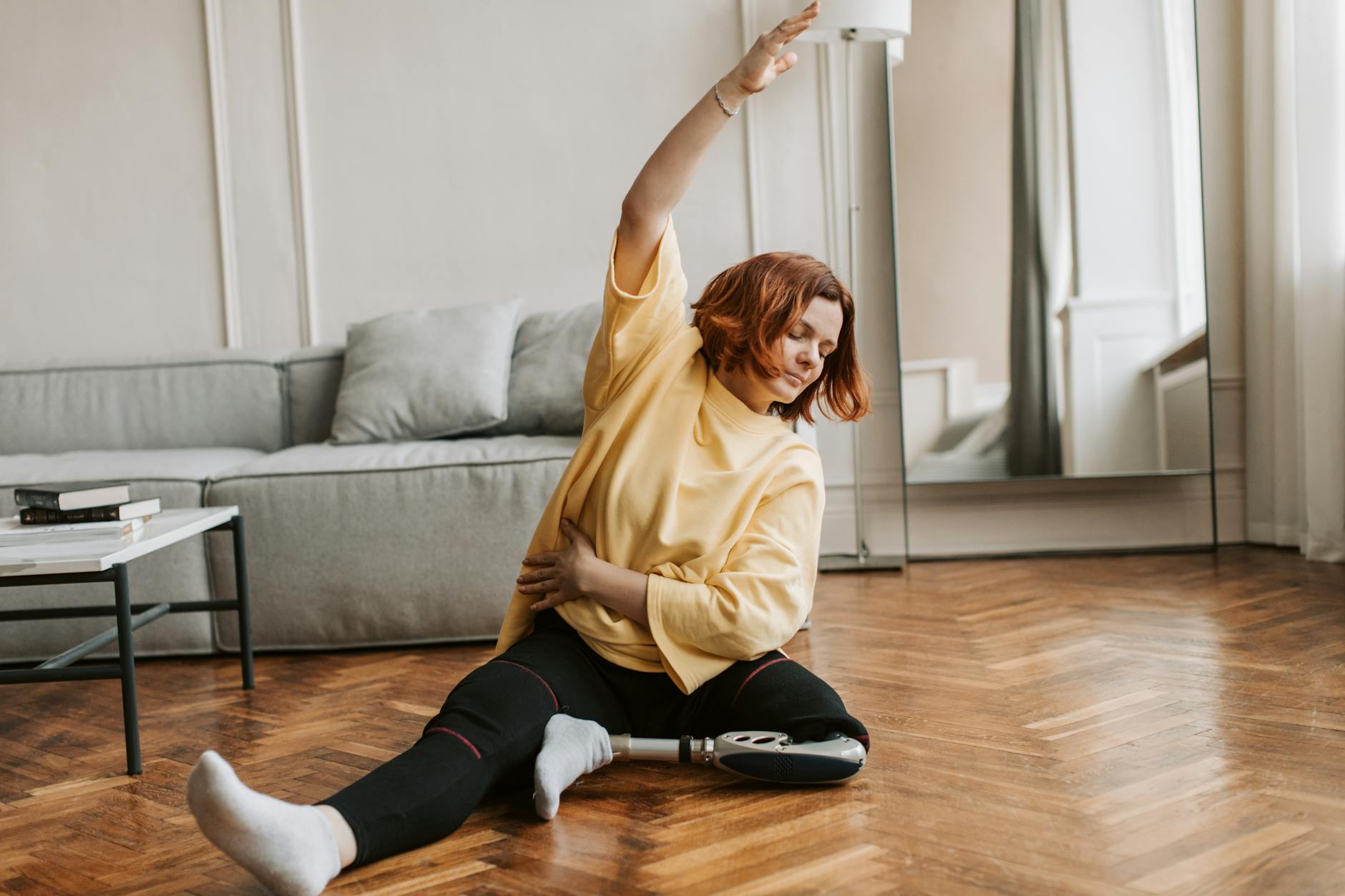 Woman doing an Excercise while sitting on the Floor