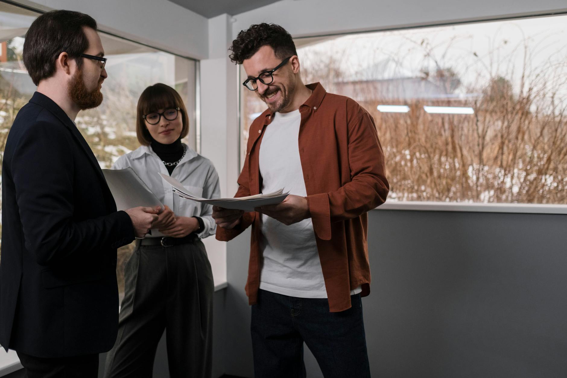 A Man Smiling While Looking at the Documents