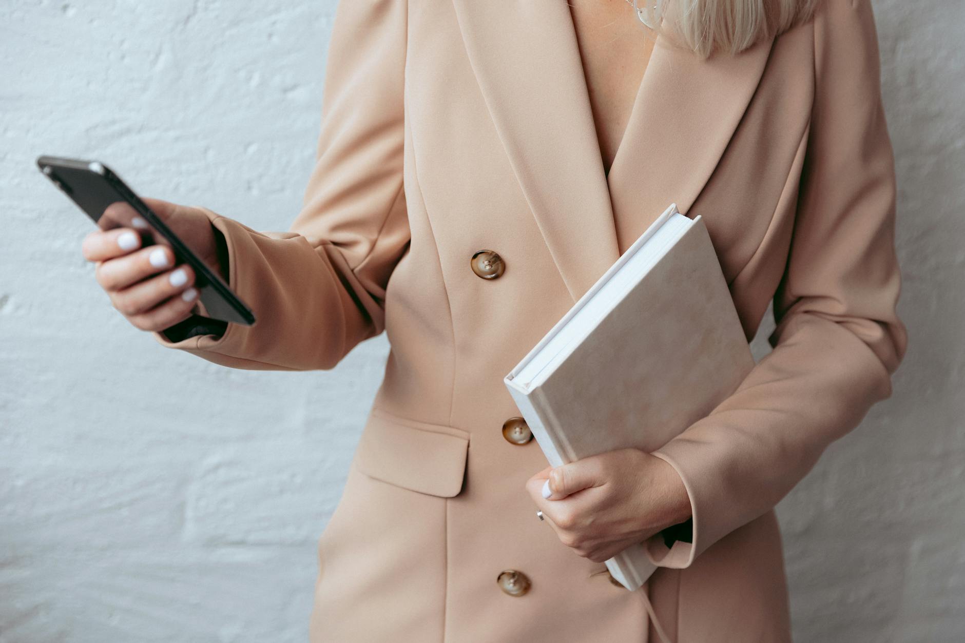 Businesswoman Holding Smartphone and Notebook