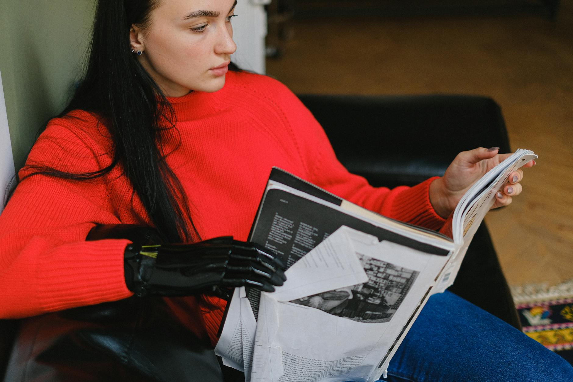 Woman With Prosthetic Hand Reading Magazine