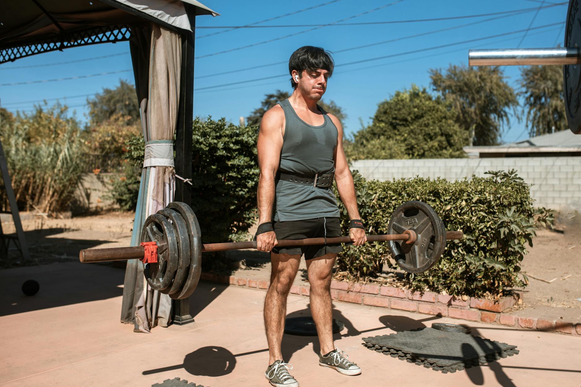 Man Carrying a Heavy Barbell