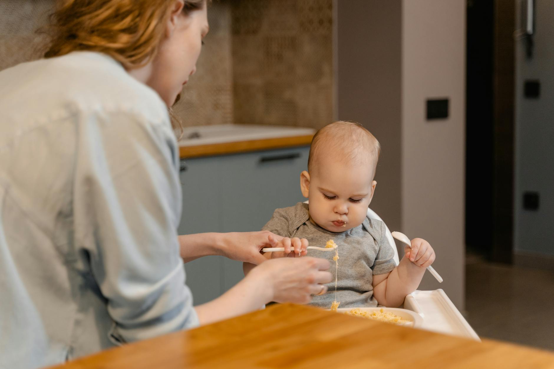 A Woman Feeding Her Child