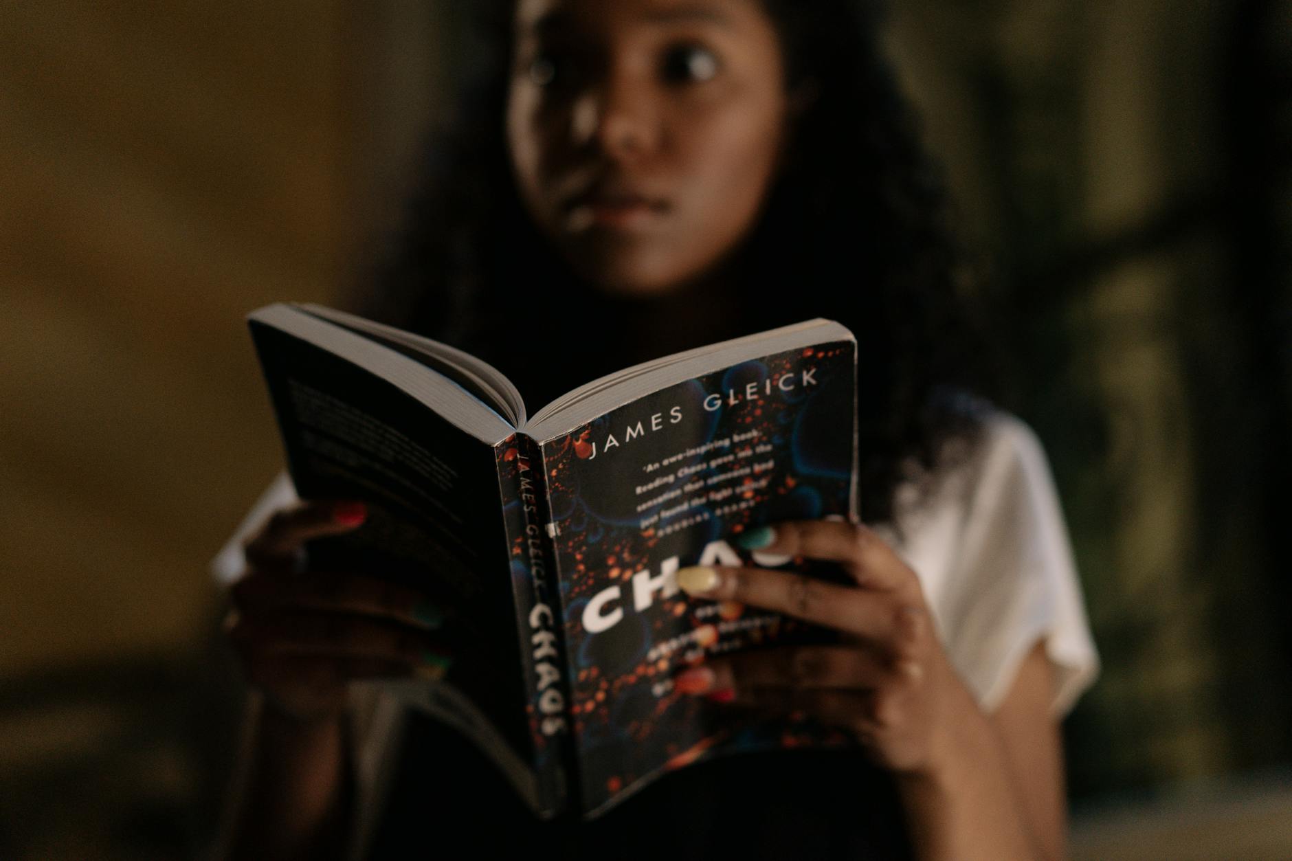 A Woman with Afro Hair Holding a Book