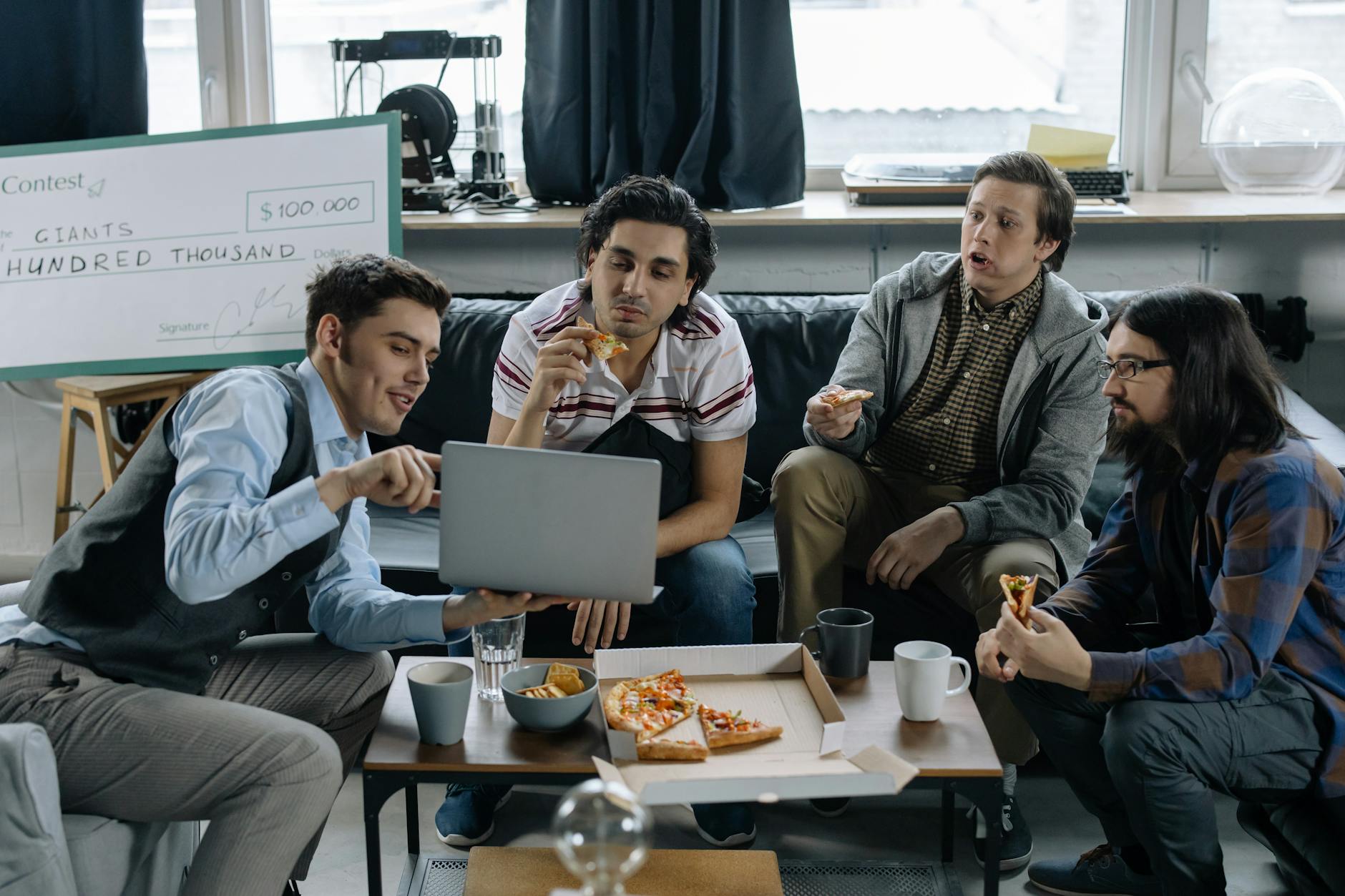 Start-Up Team Discussing a Project over a Pizza